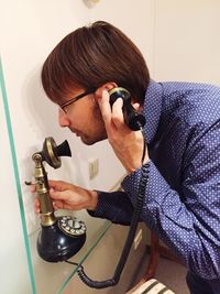 Man talking on telephone at home