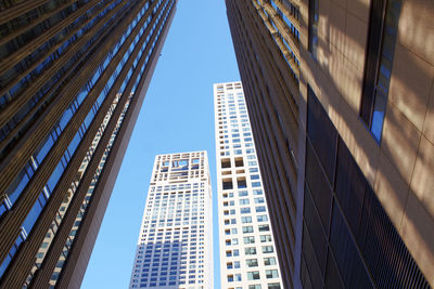 Low angle view of modern buildings against sky in city