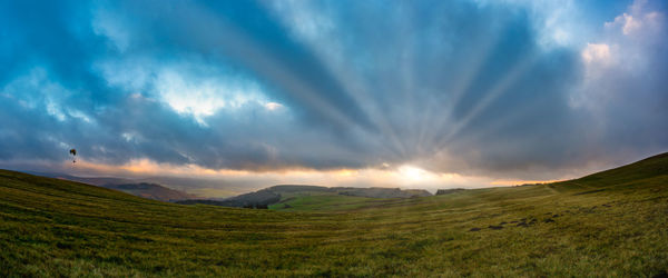 Scenic view of field against sky during sunset