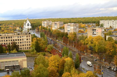 High angle view of trees and buildings in city