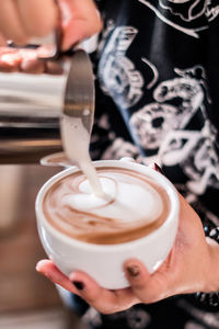 Midsection of person holding coffee cup