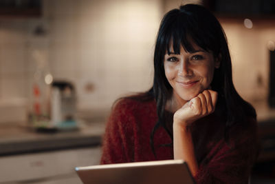 Happy woman with tablet pc at home