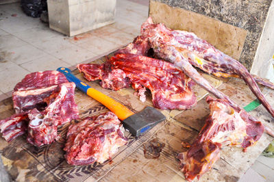 High angle view of beef with axe at butcher shop