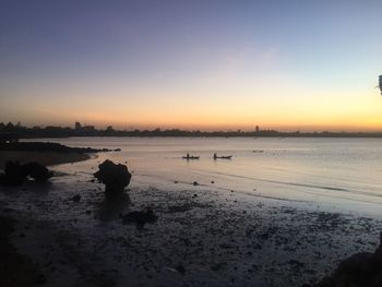 Scenic view of beach against sky during sunset