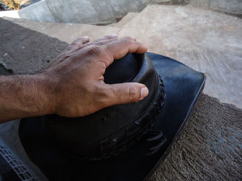 Holding a leather hat