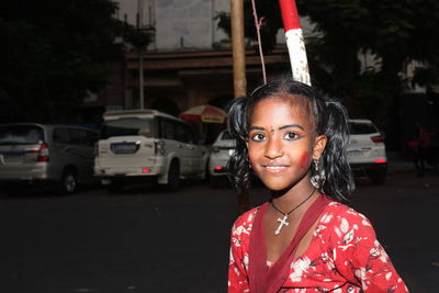Portrait of young woman standing on street