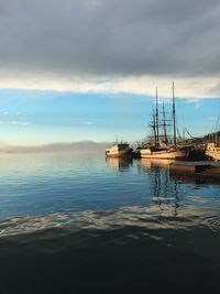 Ship moored on sea against sky