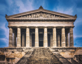 Low angle view of historical building against cloudy sky