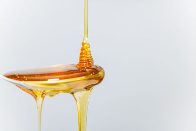 Close-up of wineglass against white background