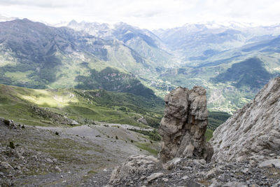 Scenic view of valley and mountains against sky