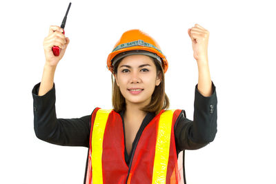 Portrait of smiling young woman against white background