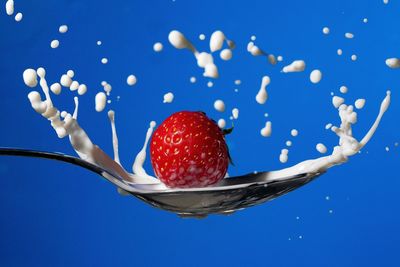 Close-up of strawberry against blue background