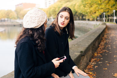 Young woman using mobile phone in winter