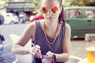 Portrait of young woman sitting on bench