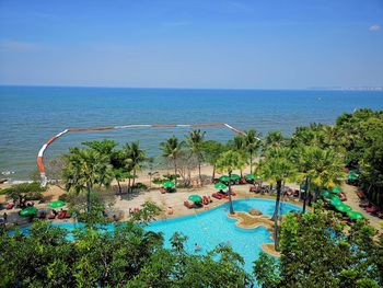 High angle view of swimming pool by sea against clear sky