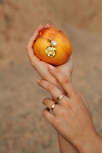 Cropped hand holding pumpkin