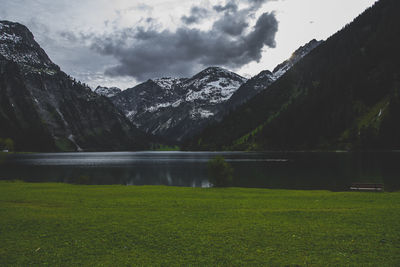Scenic view of lake and mountains against sky