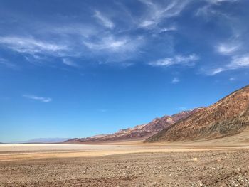 View of desert against cloudy sky