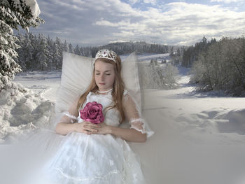 Full length of woman against snow covered land