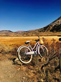  bicycle in field against blue sky