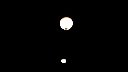 Low angle view of illuminated moon against clear sky at night