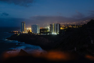 Illuminated buildings in city at night