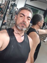 Portrait of man standing at home