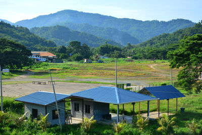 Built structure on field against mountains