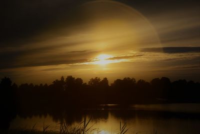 Scenic view of lake against sky during sunset