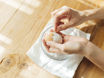 Cropped hands of person preparing food on table