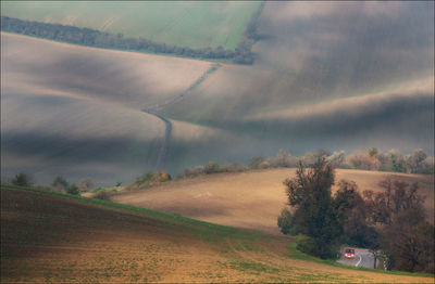 Road amidst field against sky