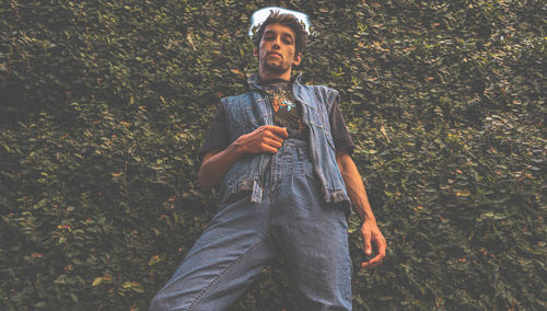 Portrait of young man standing on land