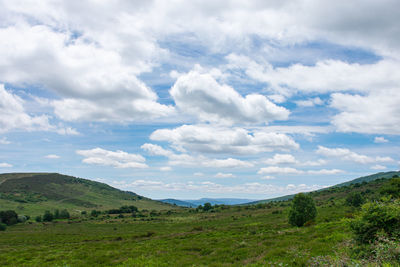 A high mountain meadow with a sky full of clouds