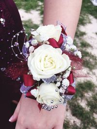 Midsection of woman holding rose bouquet