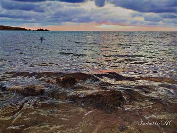 Scenic view of sea against cloudy sky