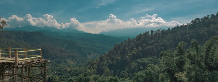 Panoramic view of trees and mountains against sky