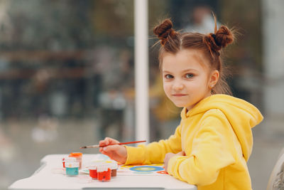 Portrait of cute girl using mobile phone