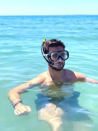 Portrait of young man swimming in pool