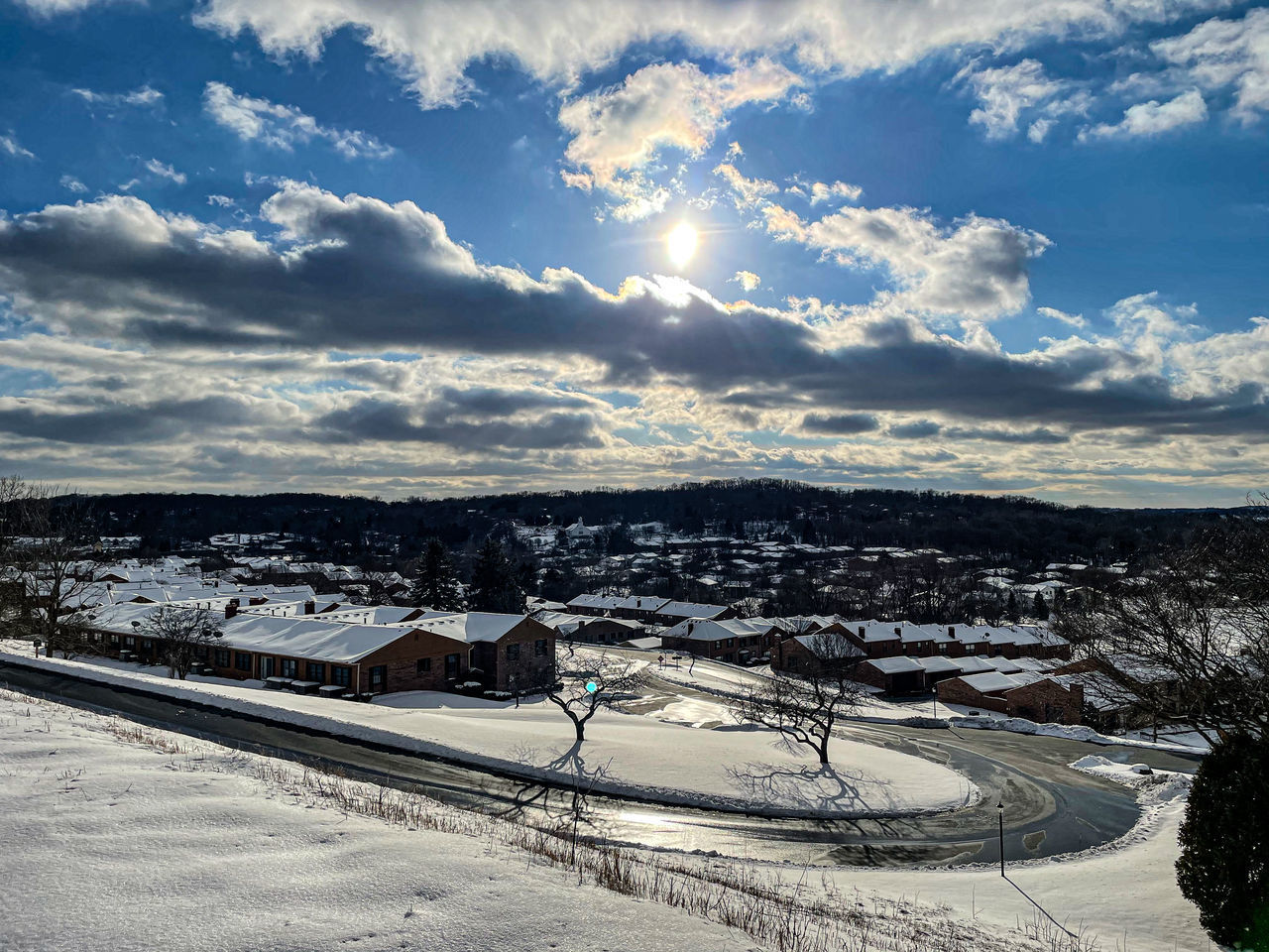 HIGH ANGLE VIEW OF SNOW COVERED BUILDINGS AGAINST SKY