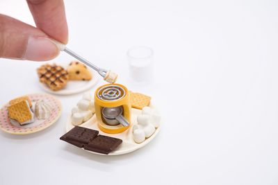Midsection of person holding food against white background