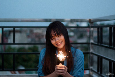 Portrait of woman with illuminated lighting equipment