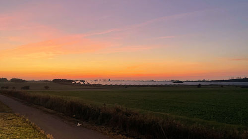 Scenic view of field against sky during sunset