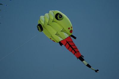 Low angle view of balloons flying against clear sky