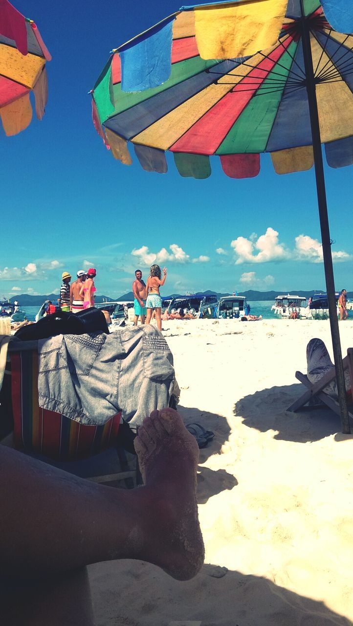 beach, sea, sand, water, shore, horizon over water, beach umbrella, sky, nautical vessel, vacations, parasol, boat, blue, sunshade, sunlight, transportation, lounge chair, moored, summer