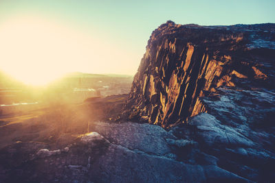 Scenic view of landscape against clear sky during sunset