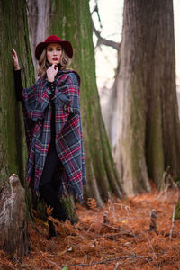 Full length of woman standing in forest