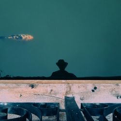 Statue by historic building against sky