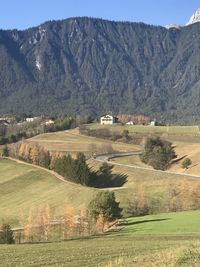 Scenic view of agricultural field by mountains