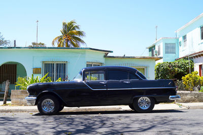 Vintage car on street against building