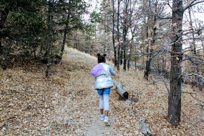 Woman walking in forest